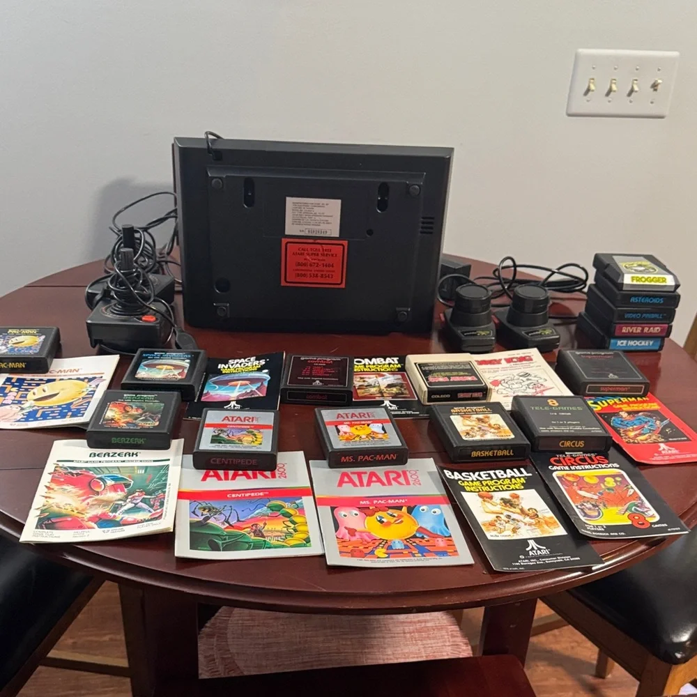 Vintage Authentic Atari 2600 with controllers, games and instruction booklets.